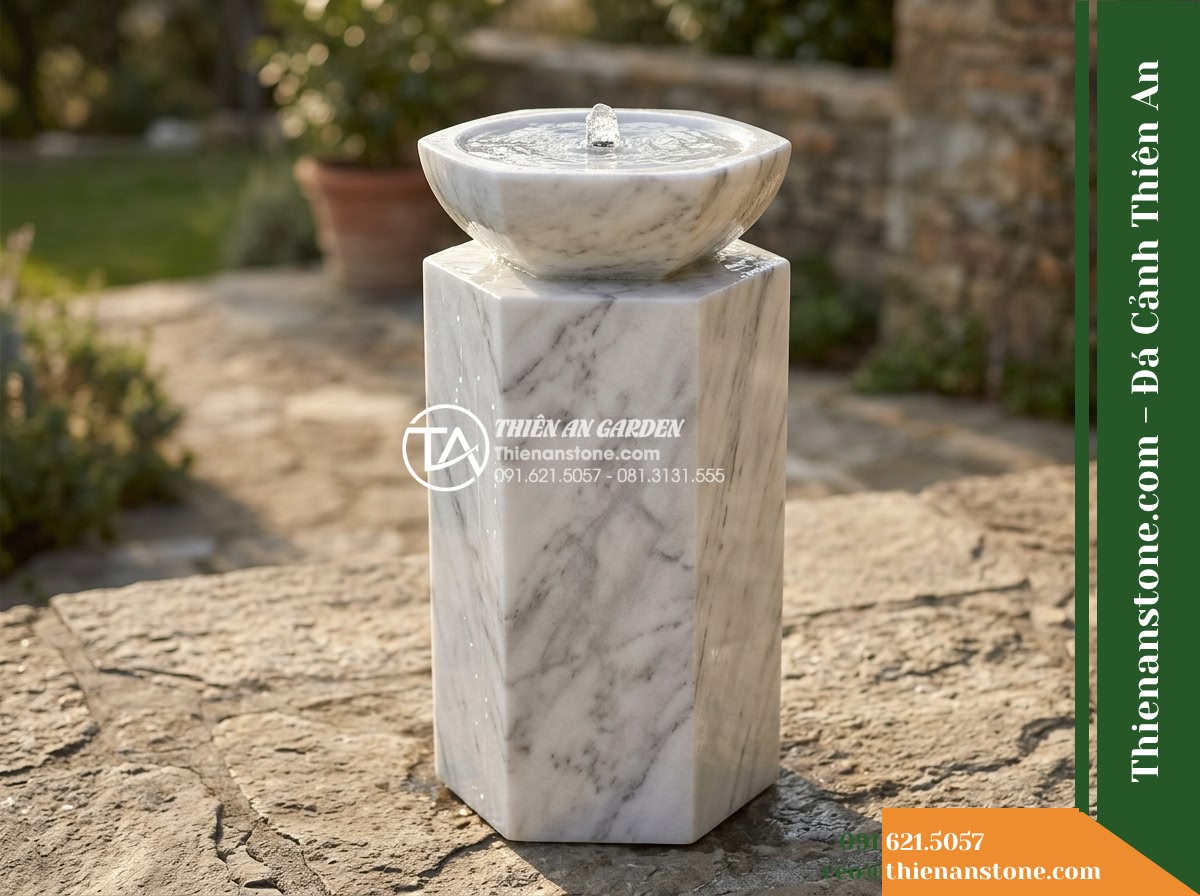Trụ Phun Lục Giác Đỉnh Bát Phun, D40cm Cao 1m - Hình 19 Trụ Phun Lục Giác Đỉnh Bát Phun, D40cm Cao 1m - Professional showcase photograph of the bespoke hexagonal stone fountain with wa