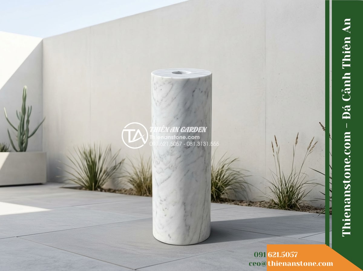 Trụ Phun Tròn Lỗ Xuyên Tâm, Mài Nhẵn D30cm Cao 80cm - Hình 9 Trụ Phun Tròn Lỗ Xuyên Tâm, Mài Nhẵn D30cm Cao 80cm - Daytime perspective of a minimalist courtyard design featuring the honed stone c
